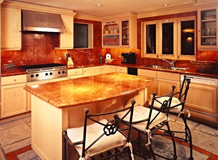 Designed for Reba McEntire in Cancun, this Hacienda style Villa. Kitchen with Rojo Alicante marble.. Architecture and Interior Design by Jarry Jacobs Design ©