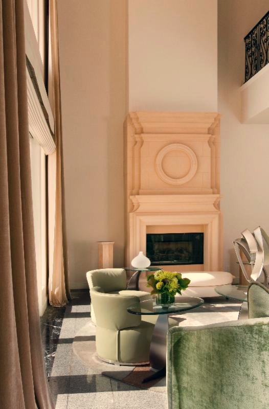 A living room with a fireplace and chairs