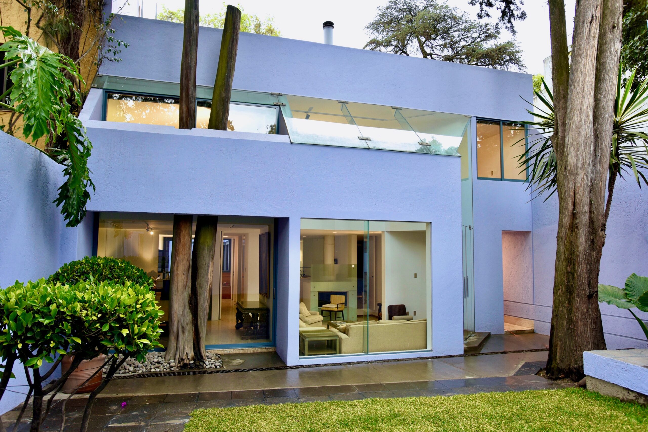 A blue house with a large glass window.