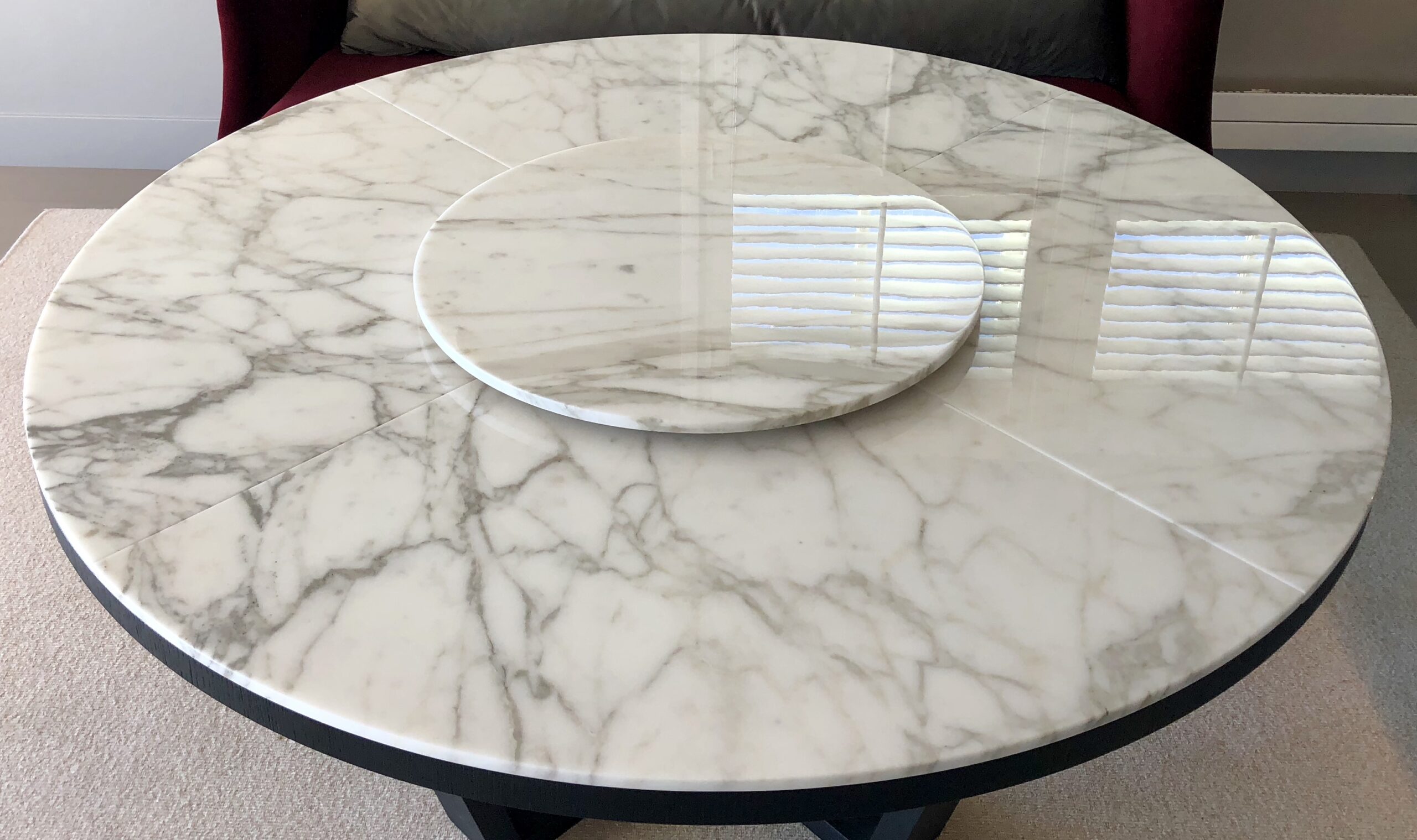 A marble table with a round plate on top.
