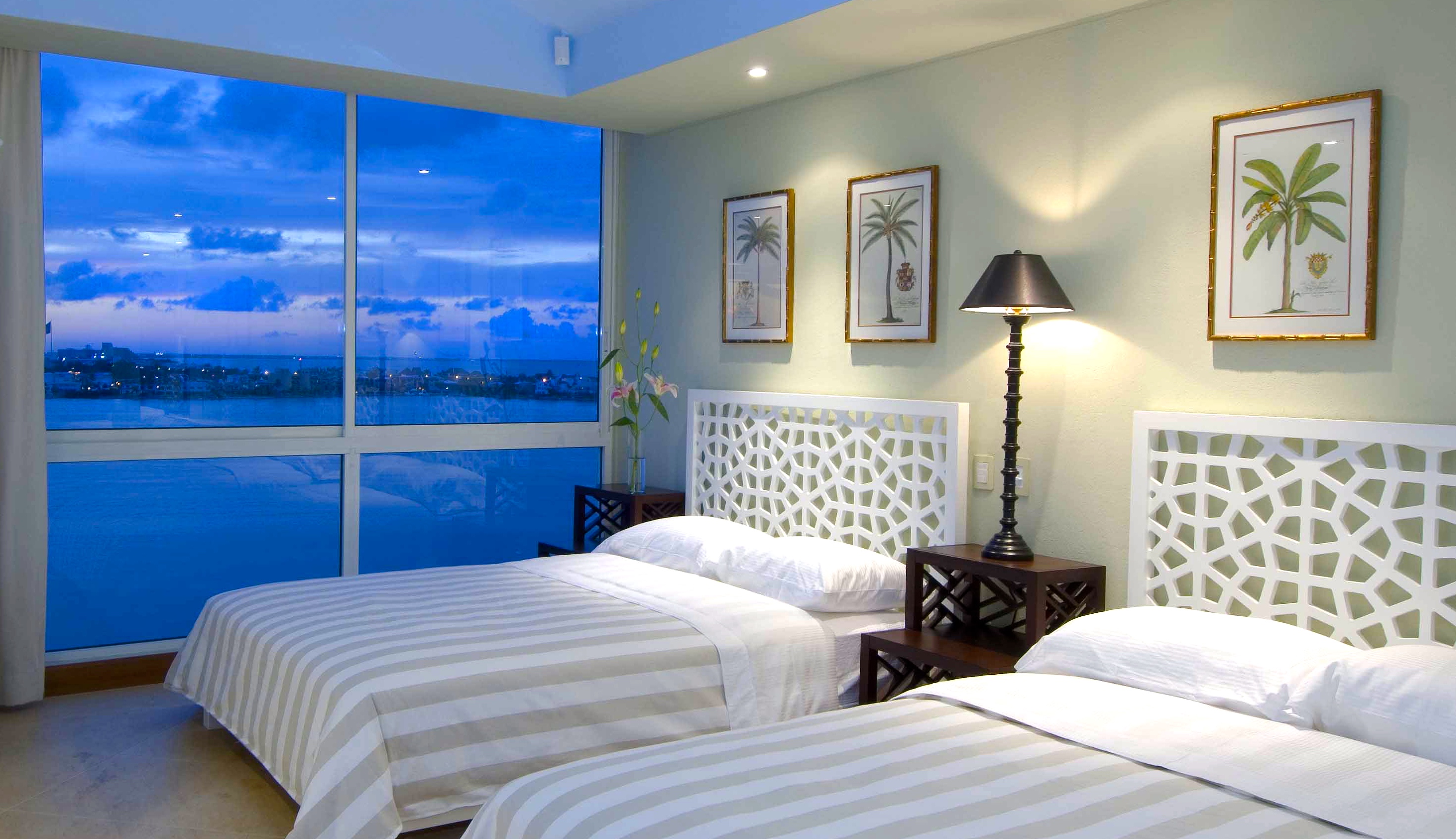 Vacation Condo Interiors. Celadon walls and blue ceiling, 2 queen size beds, with Ocean view, terrace and local craft mural. At Cancun, Mexico Condo BVG, a Jerry Jacobs Design project ©