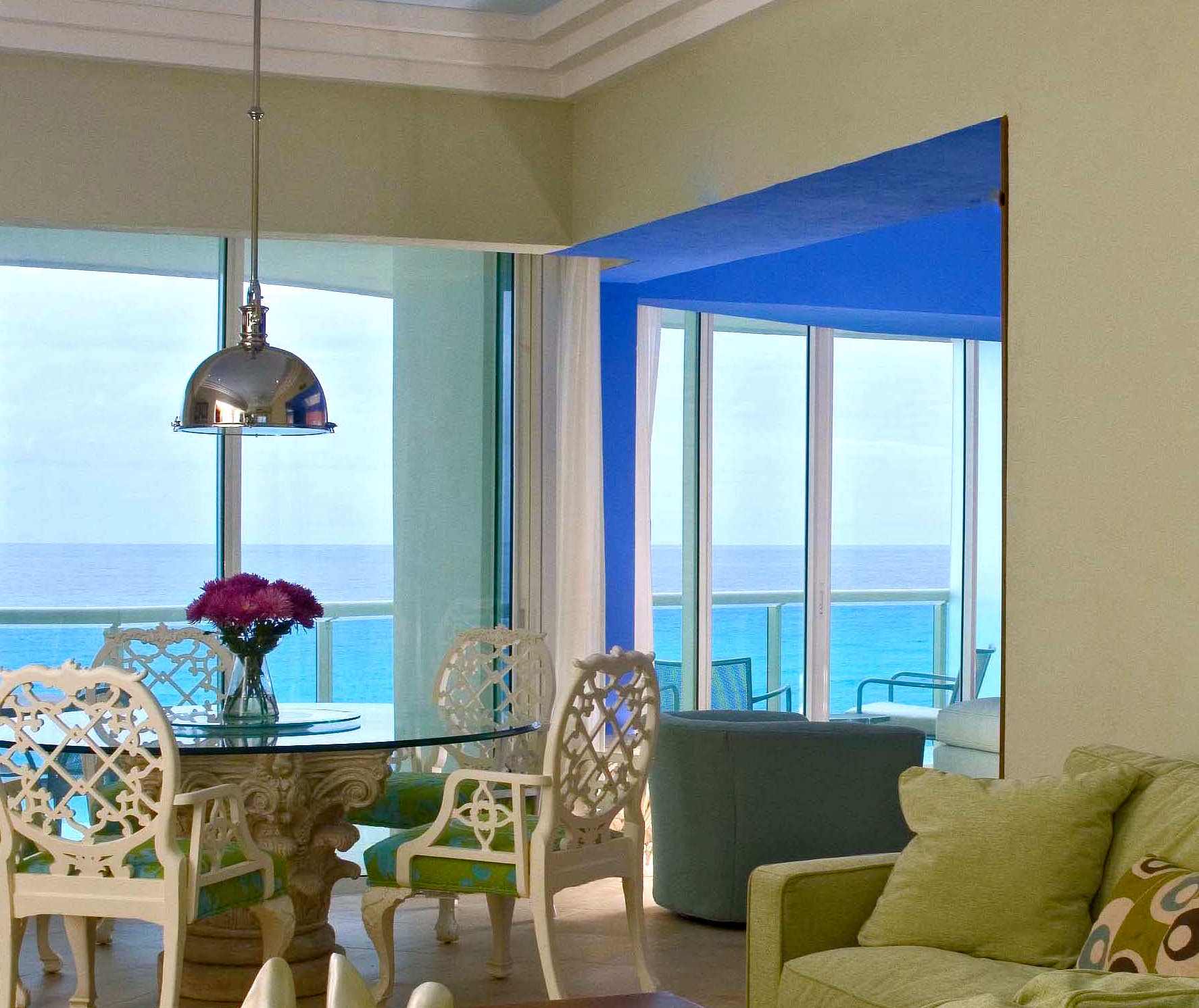 Vacation Condo Interiors. Family room and dining room with Oscar de la renta set, with Ocean view, terrace and local craft mural. At Cancun, Mexico Condo BVG, a Jerry Jacobs Design project ©
