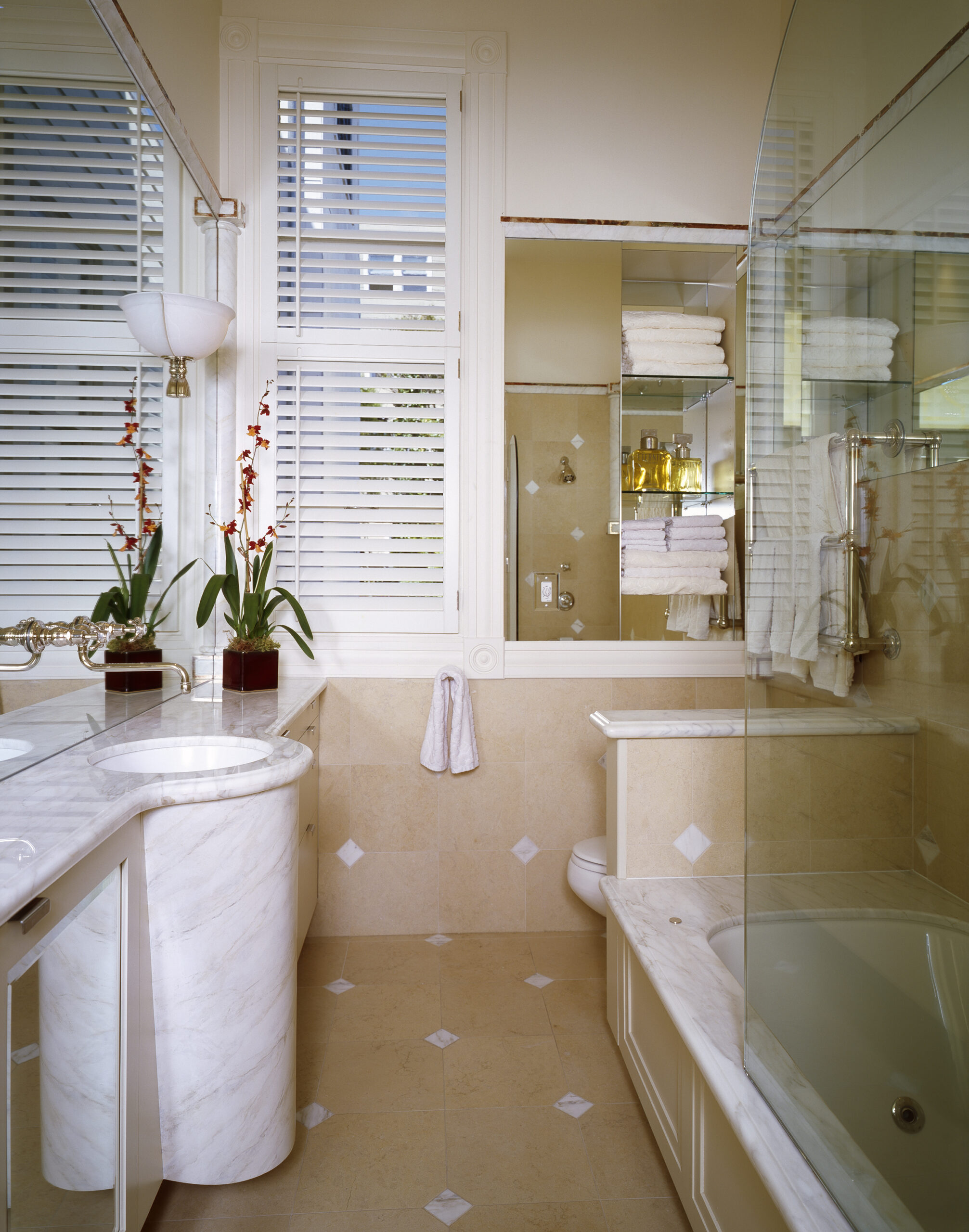 A bathroom with a tub, sink and toilet.