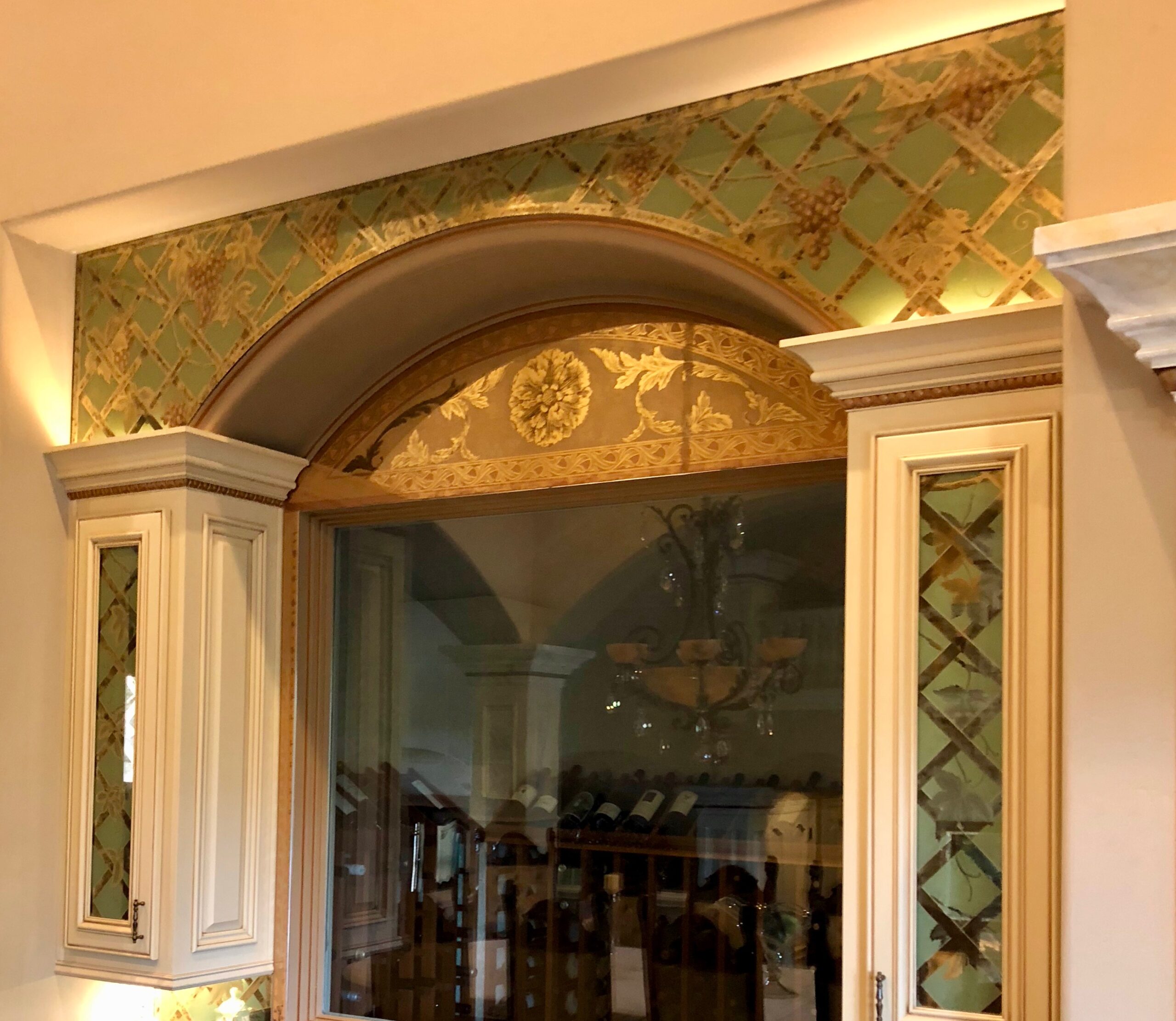 A wall with a gold leaf design on it.