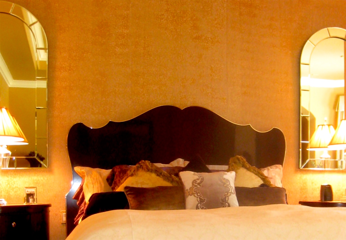 Headboard at Master Bedroom is very romantic and almost Baroque, yet the silver edge and black sheen make it contemporary. The mirrors are salvaged and purchased throughÂ 1st Dibs, while the wallpaper is hand painted.