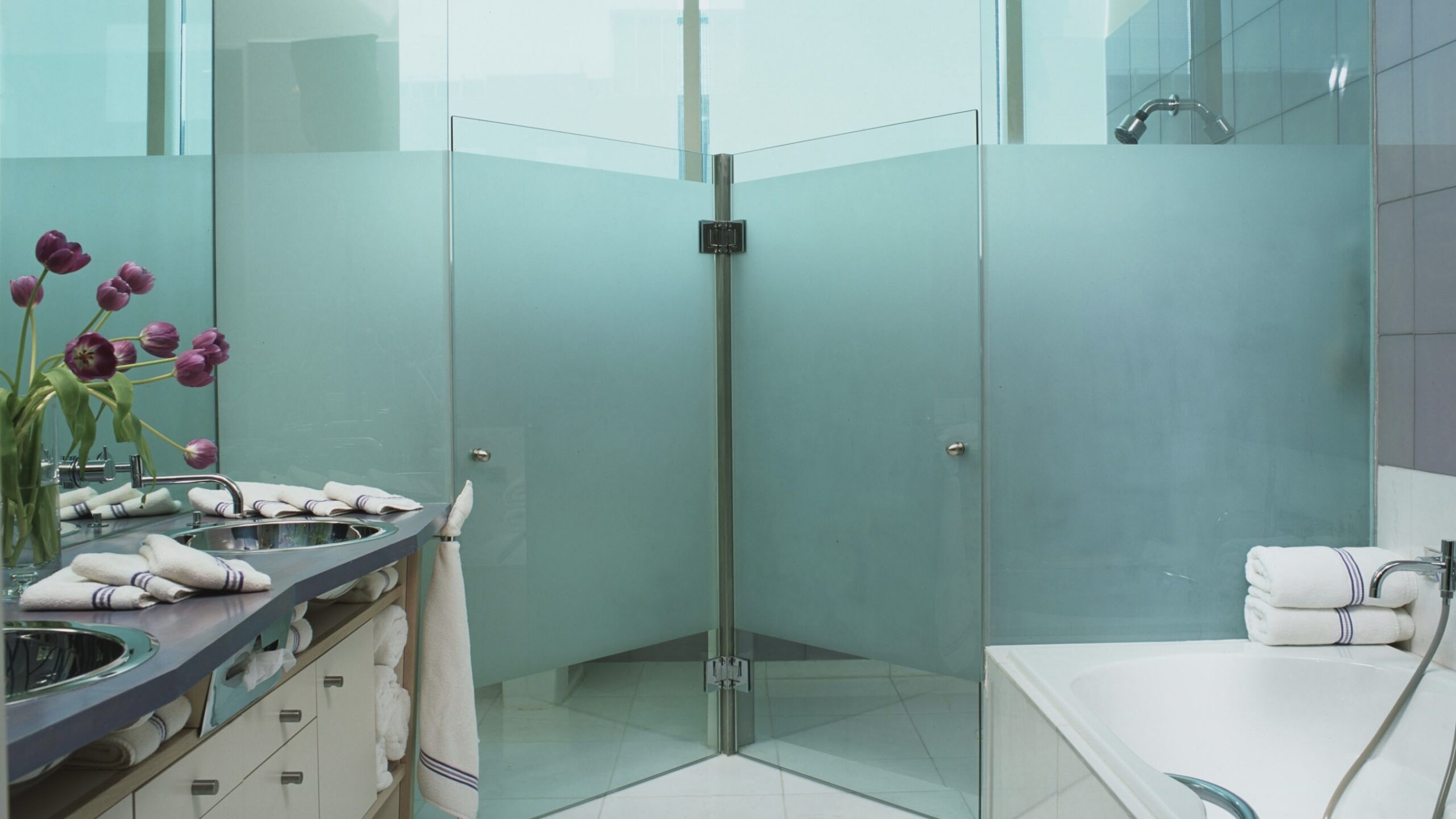 Contemporary Bathroom Designs by Jerry Jacobs Design ©.Lilac butcher block vanity, frosted glass toilet and shower stalls, Monterrey, Nuevo Leon, MX. apartment.