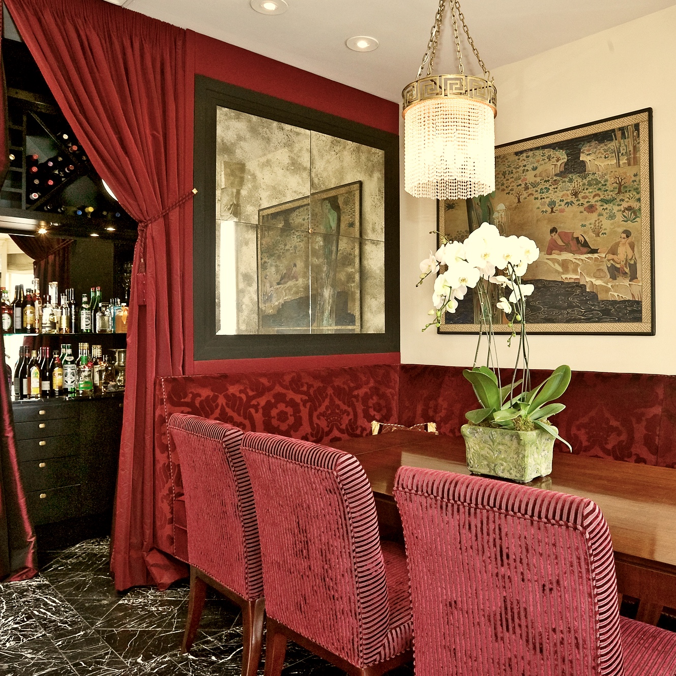 A dining room with red chairs and a table