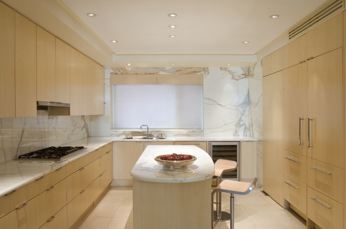 Kitchen at Polanco apartment for Art Collector. Calcutta Gold tops and splash, and English cycamore cabinetry, by Jerry JACOBS DESIGN.