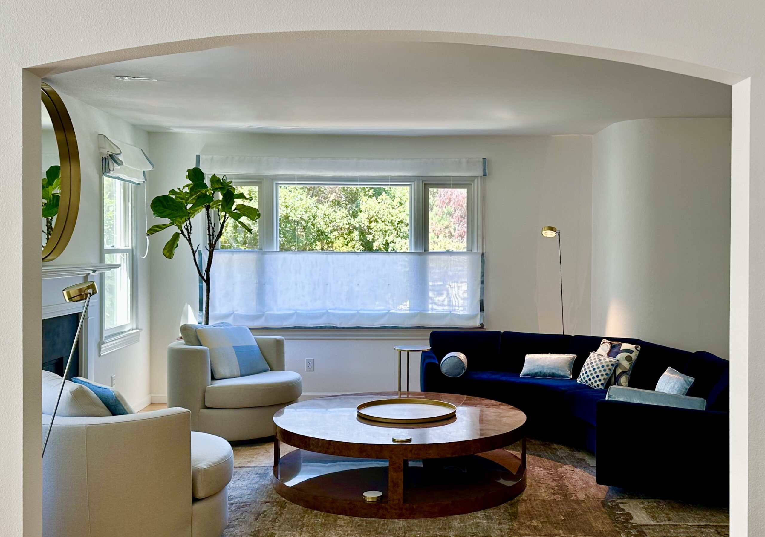 Larkspur home.Living room from dining room. Top down sheer and curved sectional against corner protrusion.