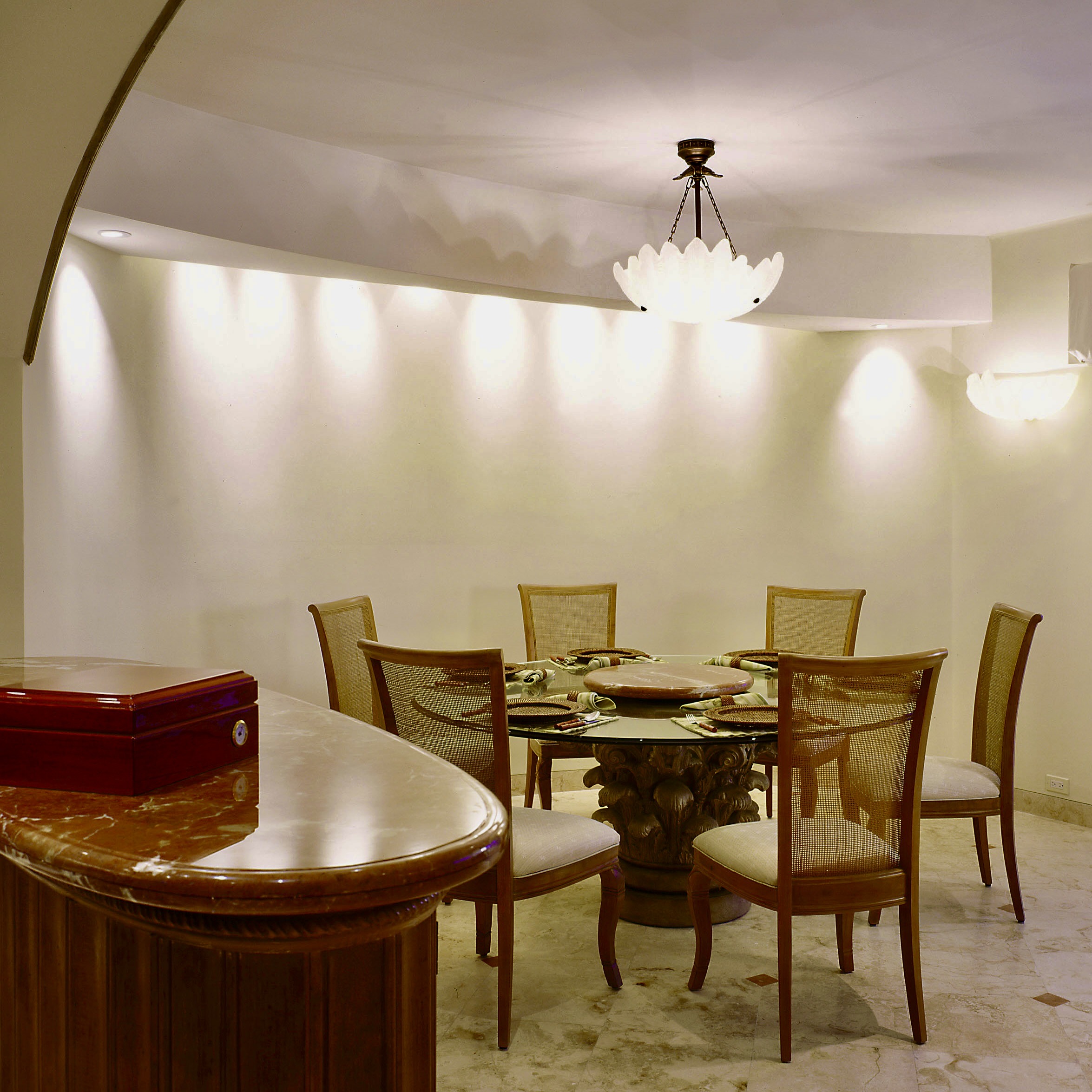 Interior Designer dining rooms, curved wall and round glass top table at Waterfront Townhouse.