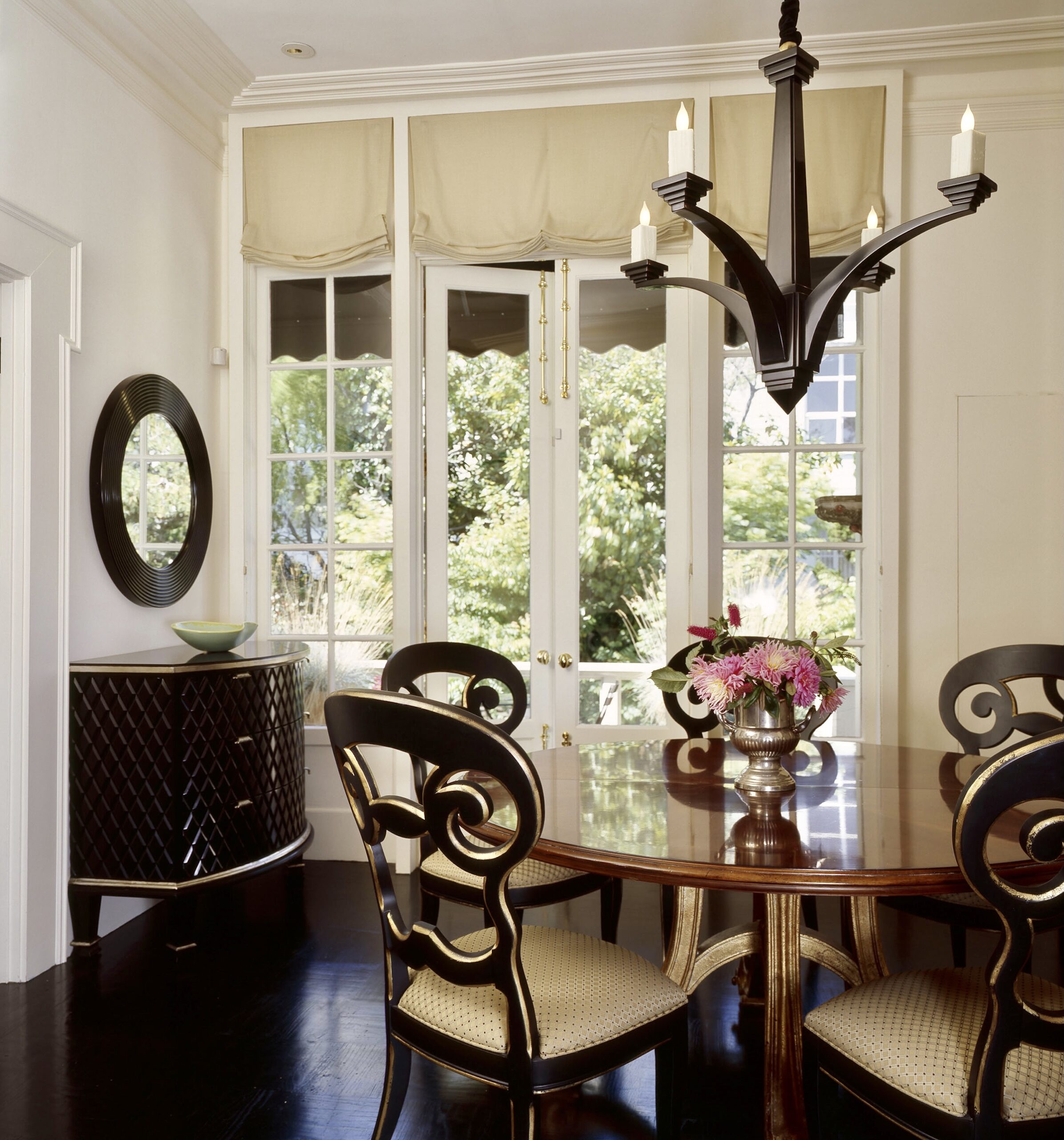 Interior Designer dining rooms. Almost all black, the floor, the consoles, and the chandelier.