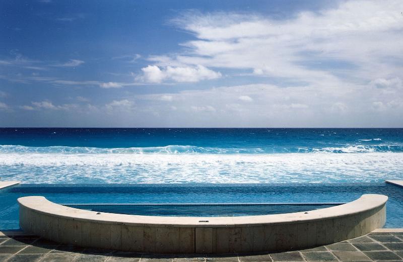 A pool with an ocean view and a sky background