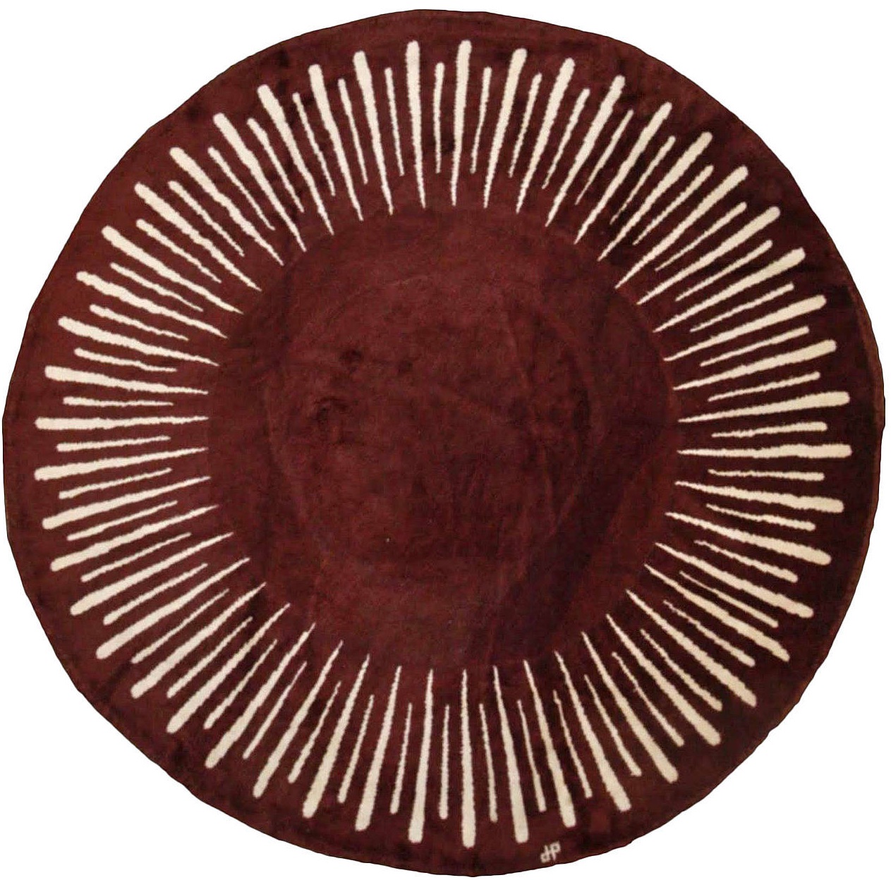 A round rug with white lines on it.