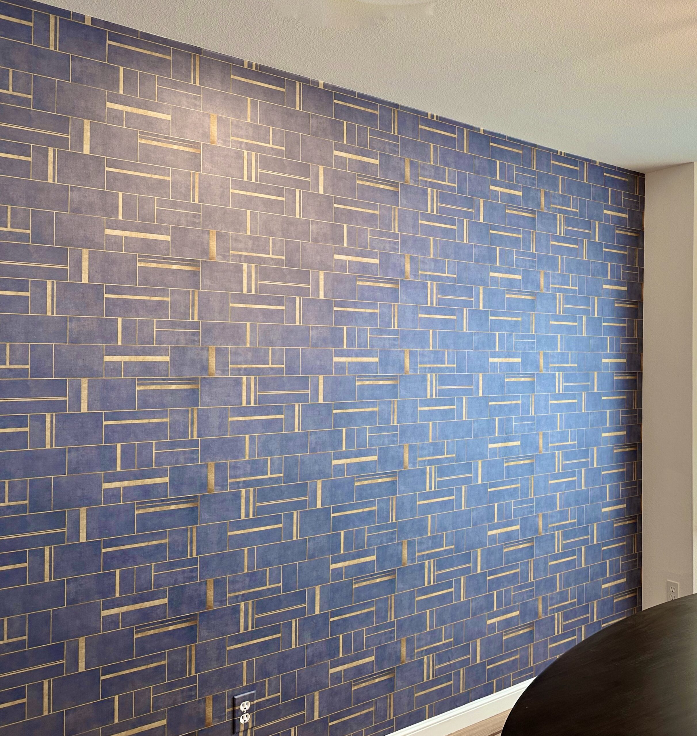 A wall with blue and gold tiles on it