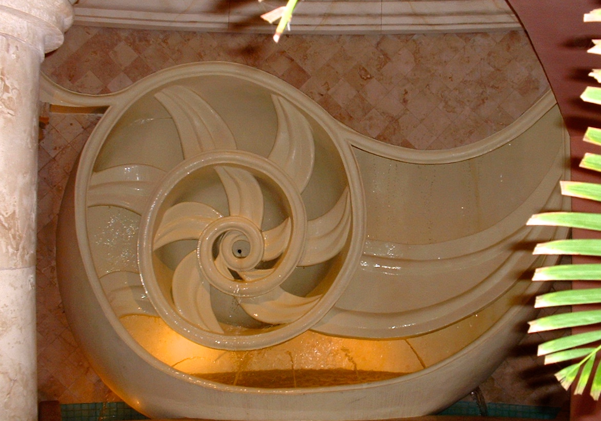 A spiral staircase with a light on the bottom of it.