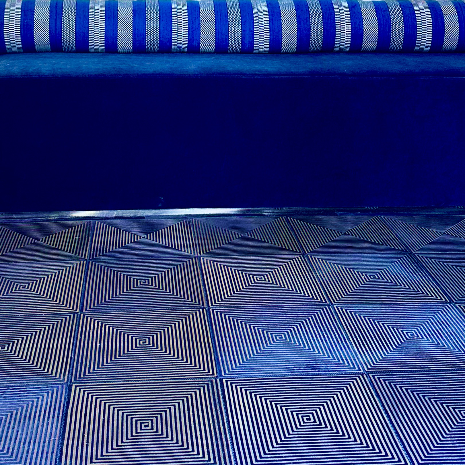 The Foyer. A blue rug of laser printed hide, a velour bench and a striped pillow make the foyer coloring. Yet to come the wall with the Art.